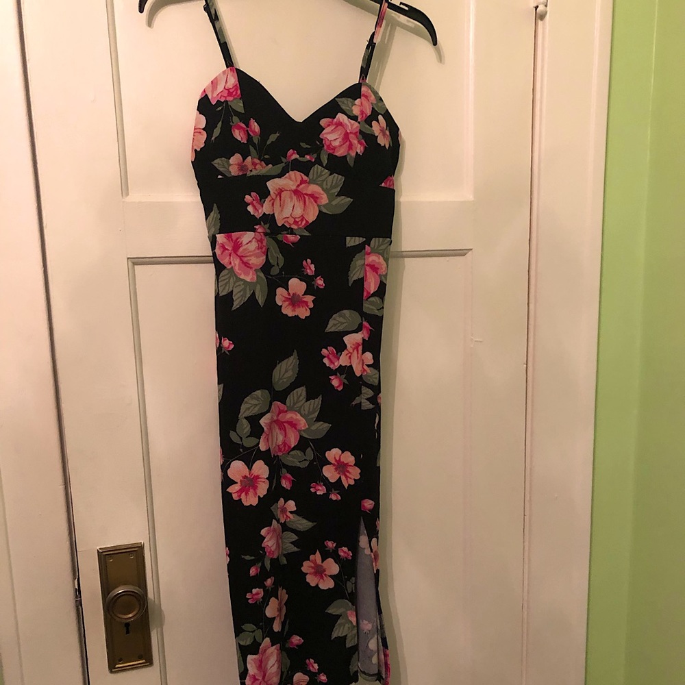 Form fitting floral material,padded support, left slit in leg, spaghetti straps.